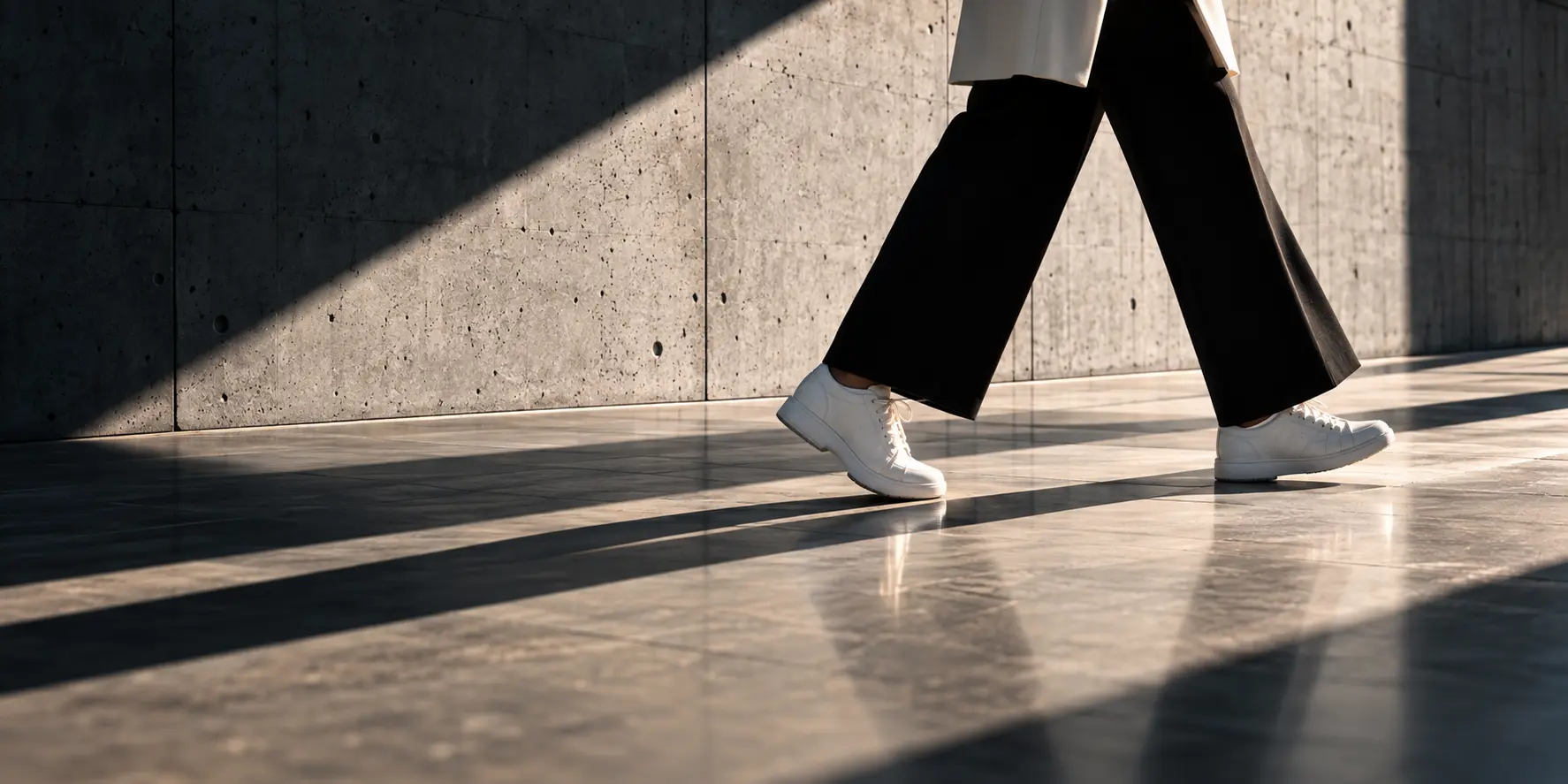 A professional moving with purpose through an architectural workspace